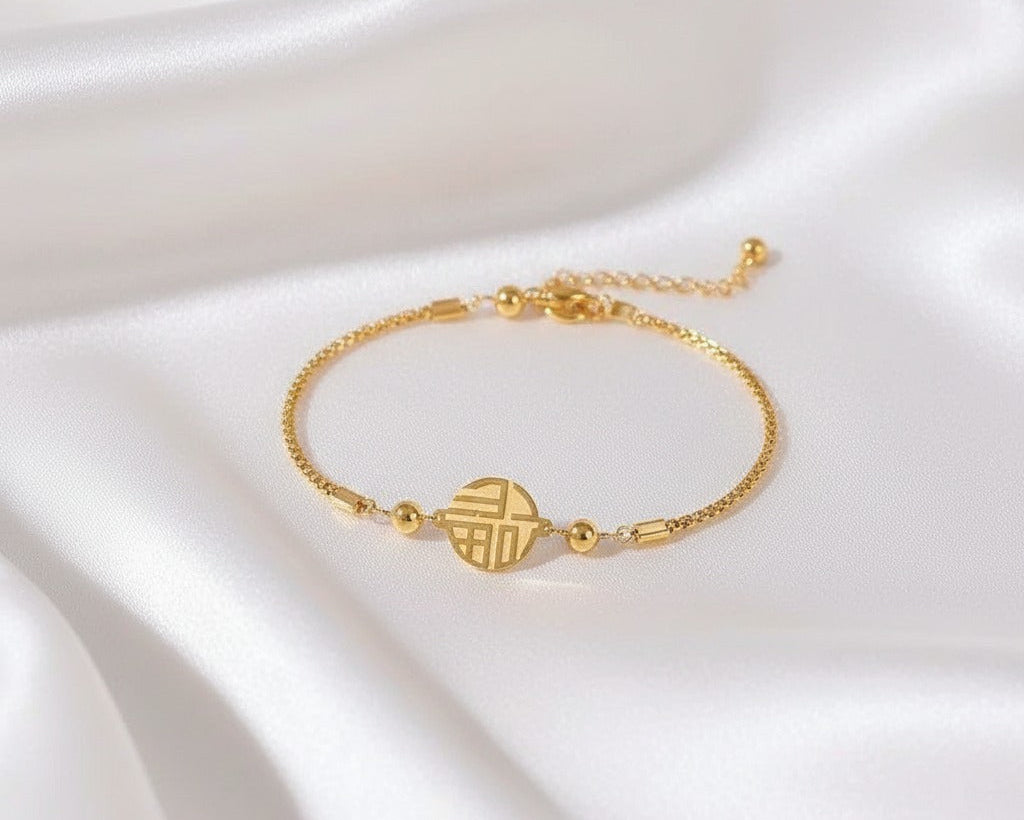 Gold bracelet on a white satin background