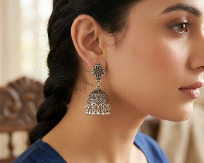Woman wearing a silver earring with a blurred background
