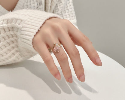 Hand wearing a rose gold ring with a white background