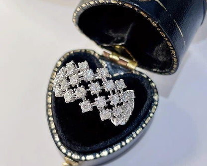 Silver diamond earring in a heart-shaped jewelry box on a white background