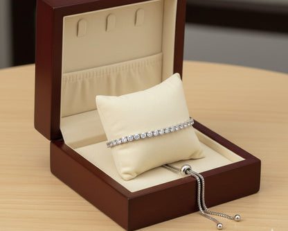 Silver bracelet in a wooden jewelry box on a wooden surface