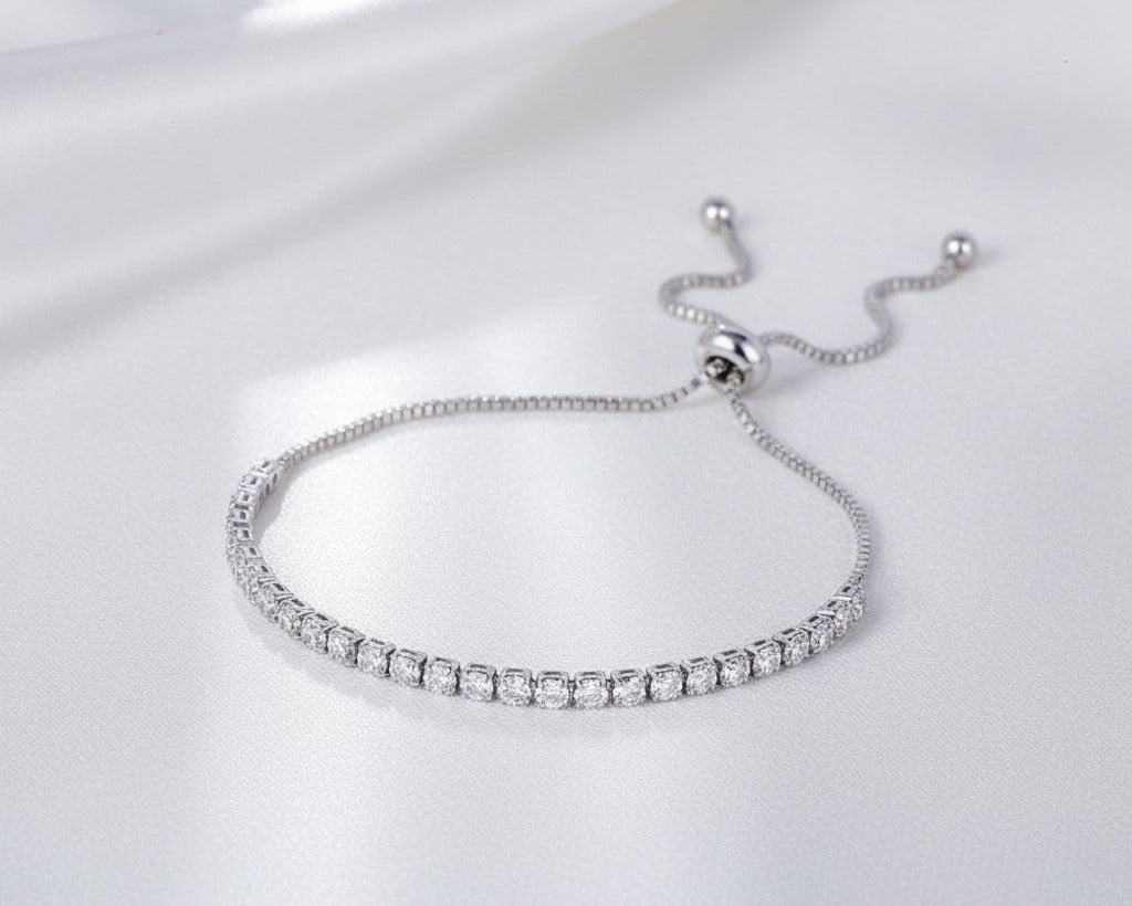 Silver bracelet with clear stones on a white background