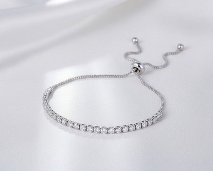 Silver bracelet with clear stones on a white background