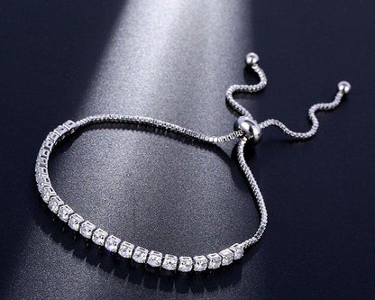 Silver bracelet with clear stones on a dark background