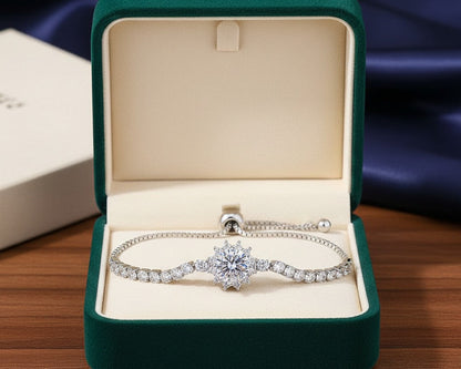 Diamond bracelet in an open green jewelry box on a wooden surface with a dark fabric background.
