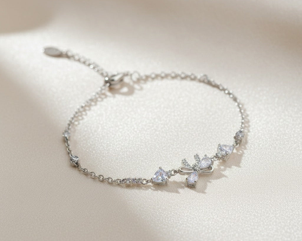 Silver bracelet with diamond-like stones on a light background