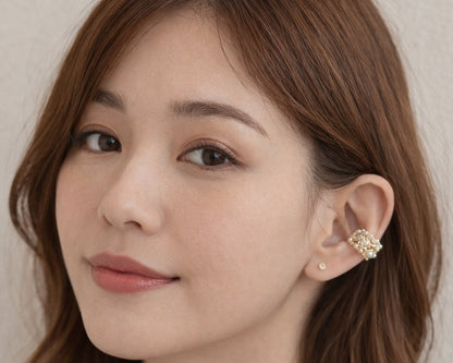Woman wearing a floral earring with a neutral background