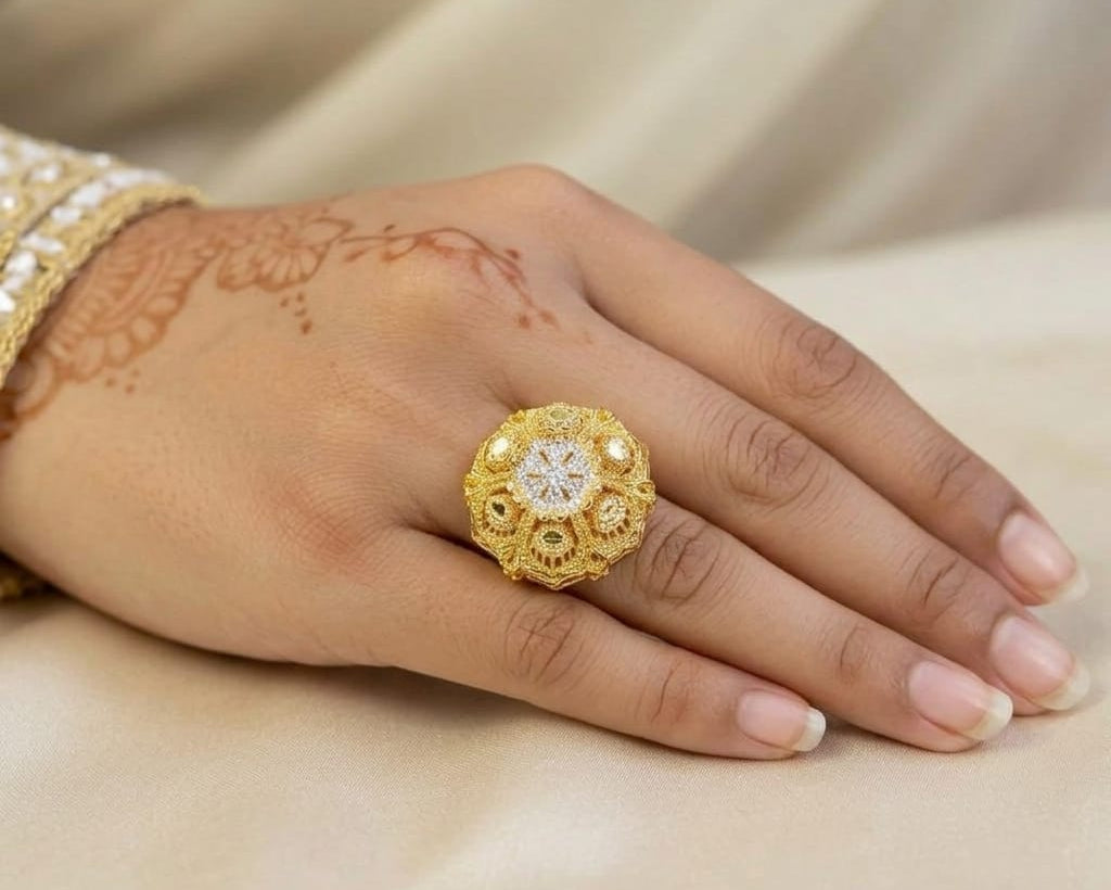 Gold ring with diamond on a hand with henna design