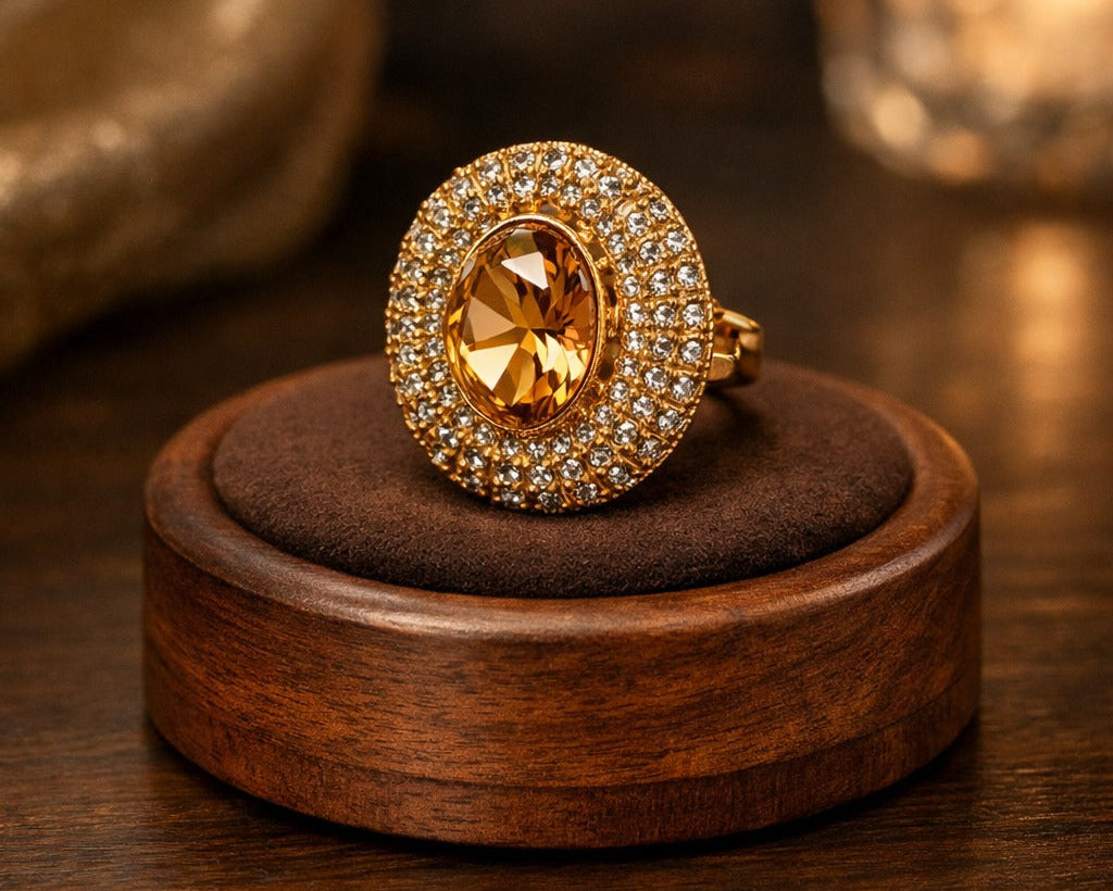 Gold ring with a large gemstone on a wooden stand